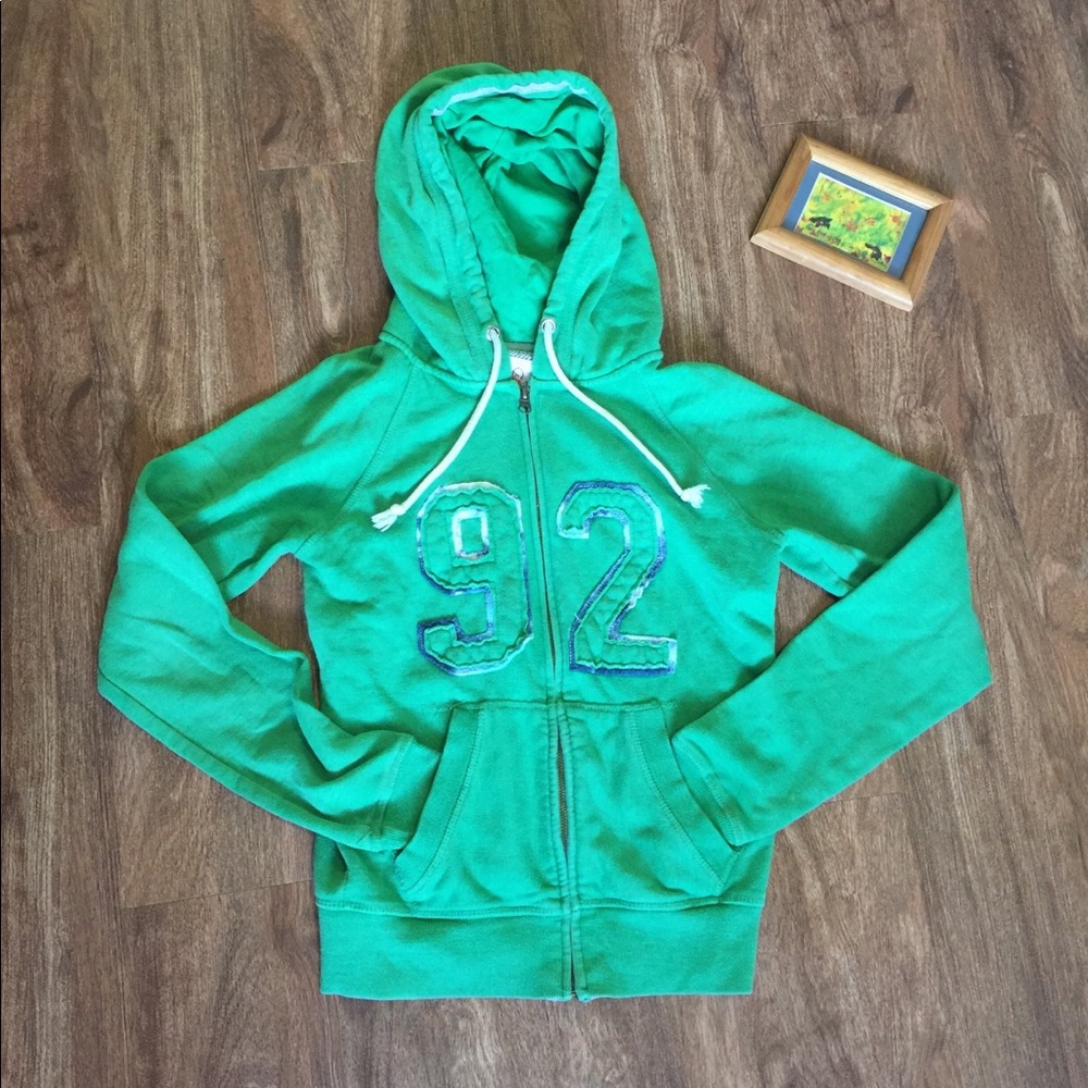 Green zip up hoodie.